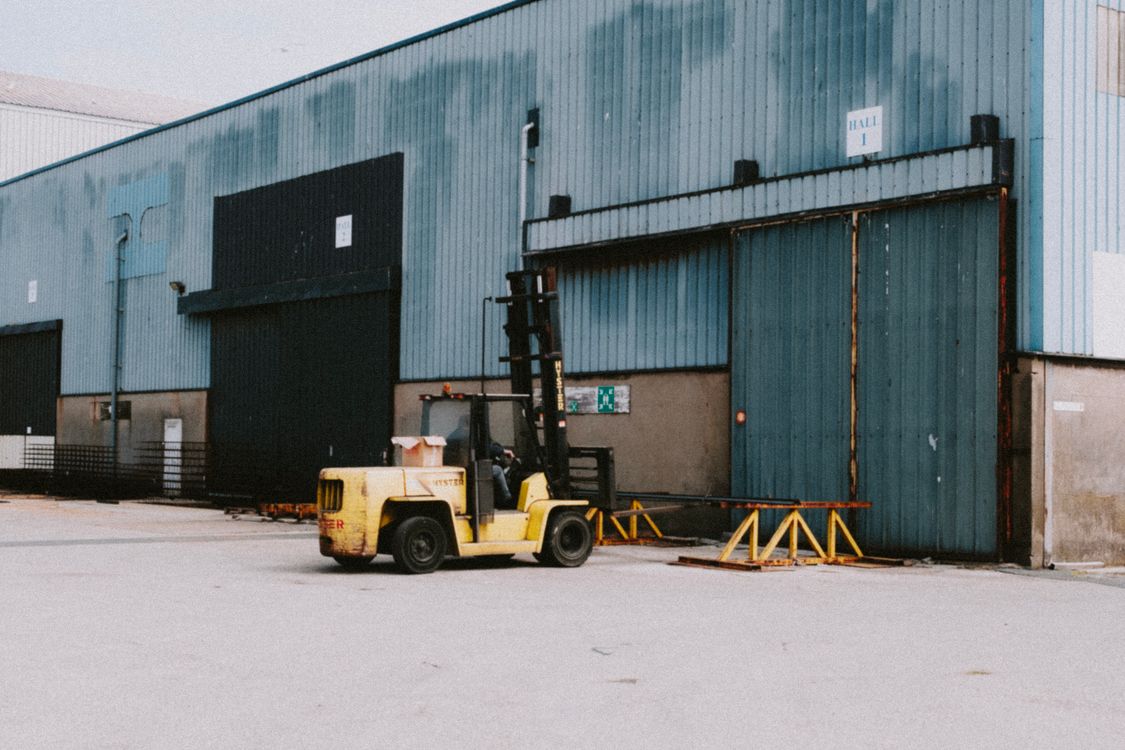 Reference photograph of a forklift outside an industrial warehouse
